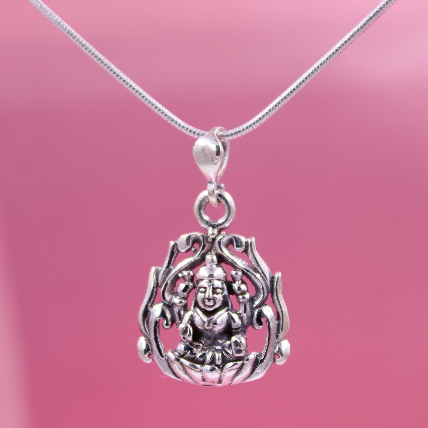 Sterling silver guardian pendant on pink background