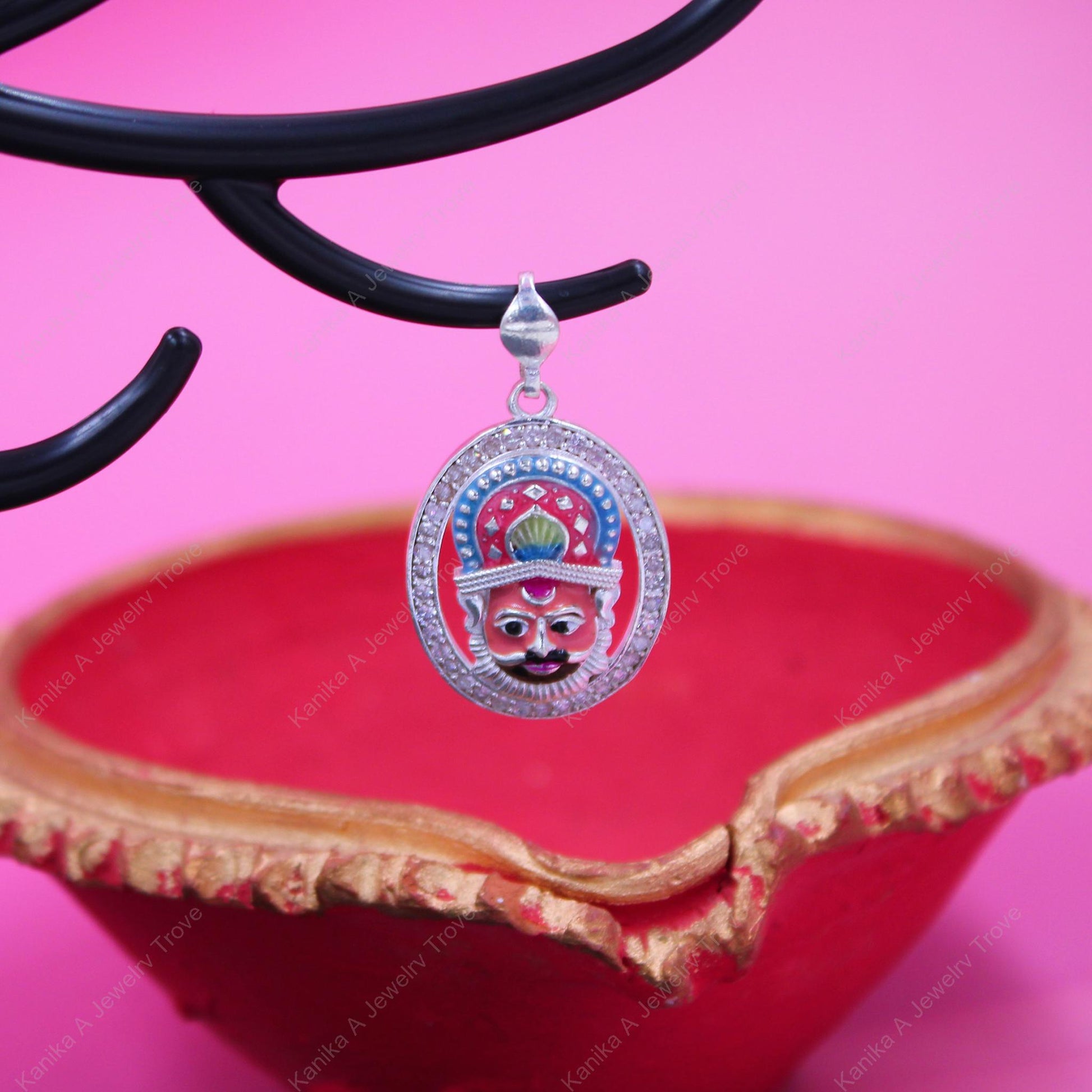 Intricate deity pendant, diamond-studded with vibrant colors