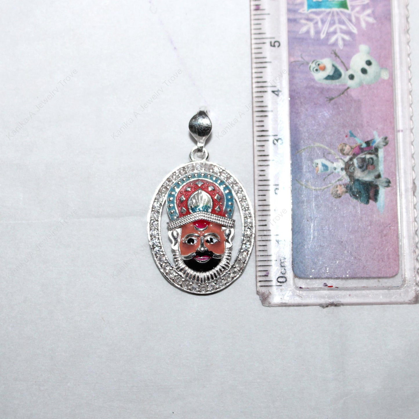 Ethnic Indian silver pendant featuring divine face design