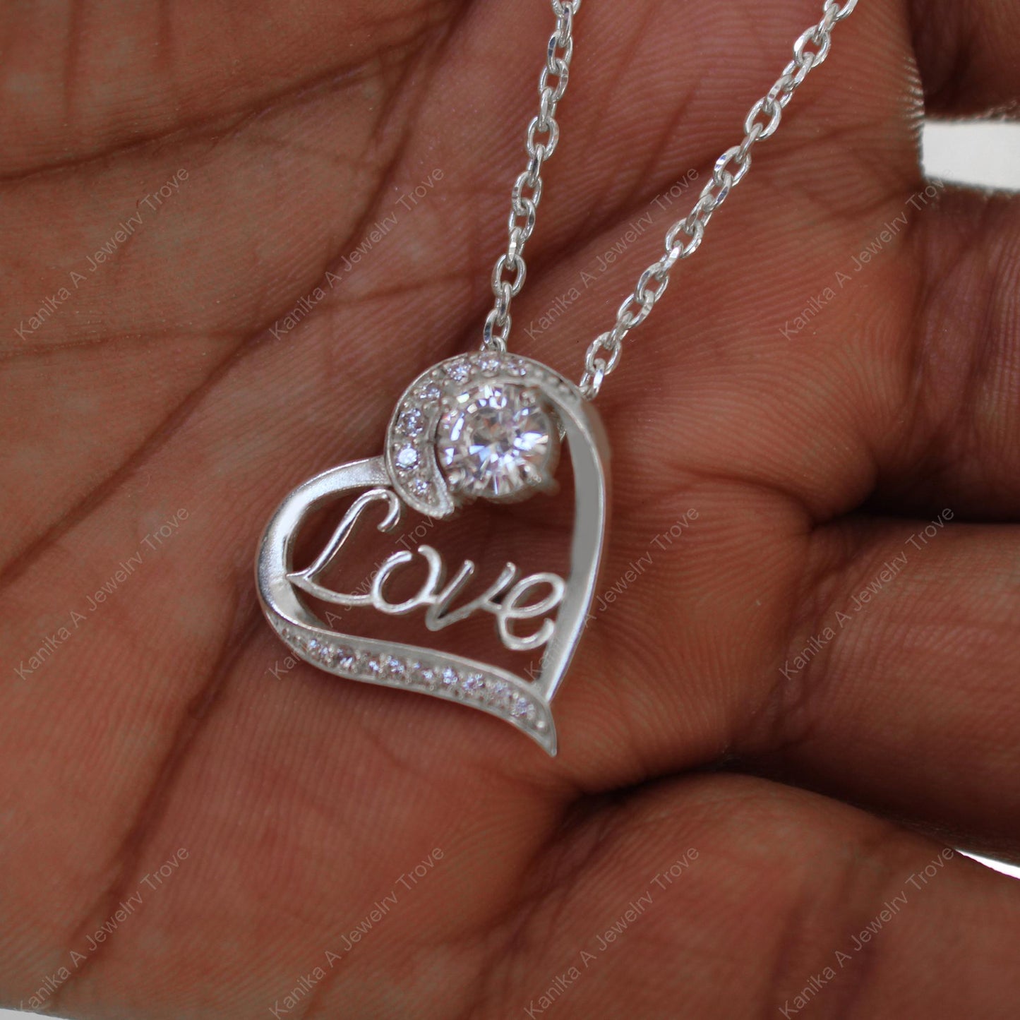 Silver necklace with cursive love design and gemstone