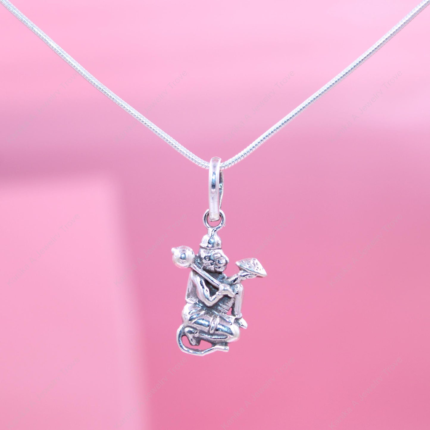 Intricate deity charm in sterling silver