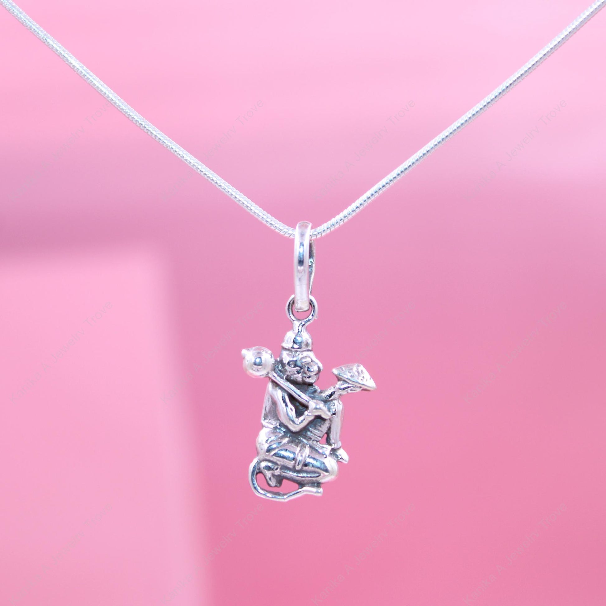 Intricate deity charm in sterling silver