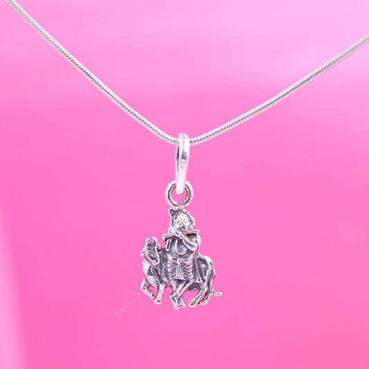 Silver Krishna and Cow pendant necklace on pink background